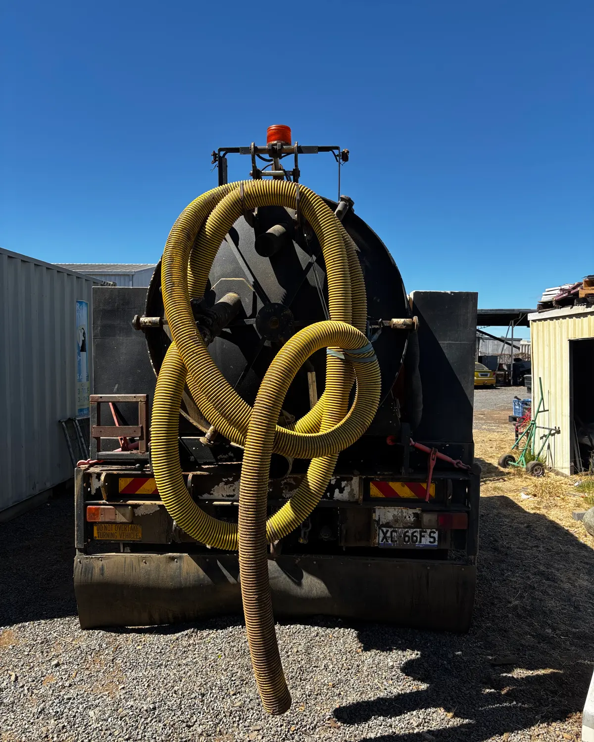 Rear of the vacuum truck with suction hoses