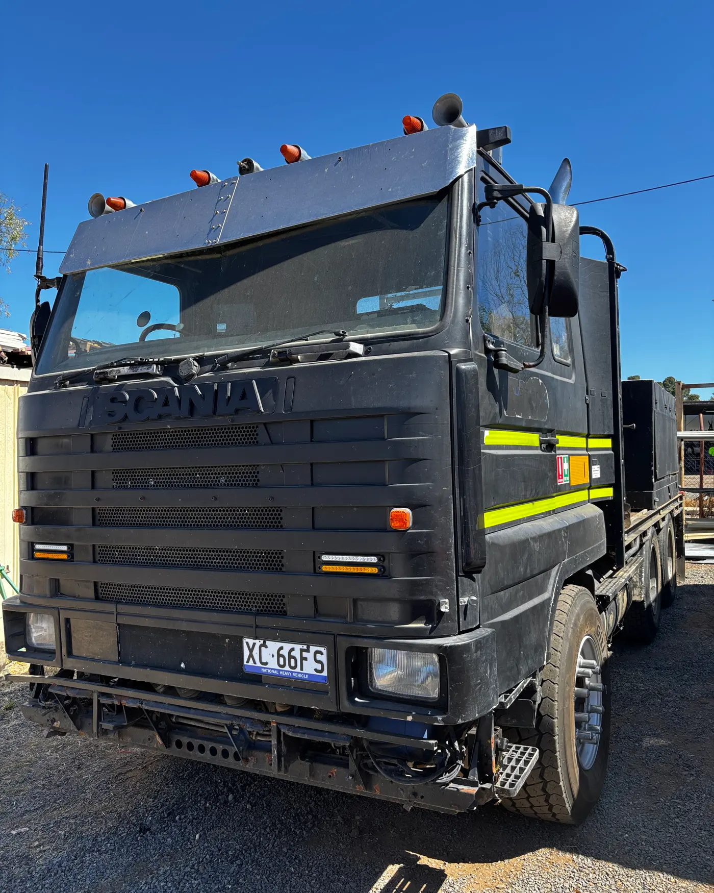 Black Scania vacuum excavation truck, front view