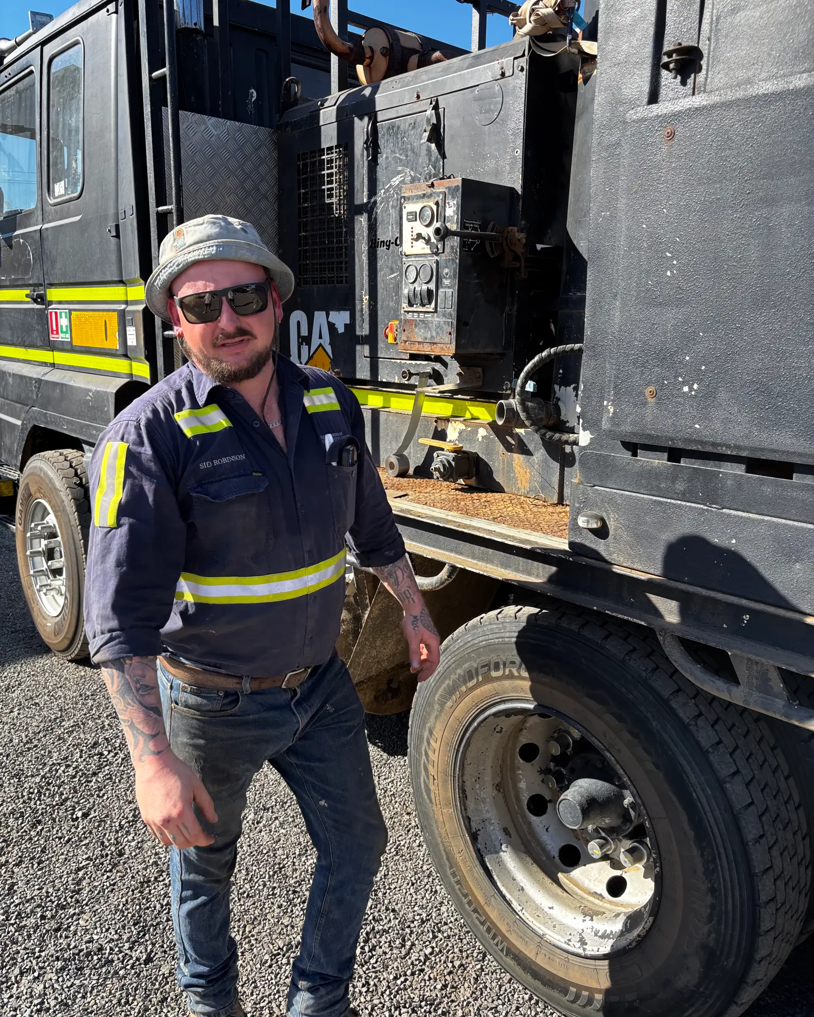 Sid Robinson beside the vacuum truck